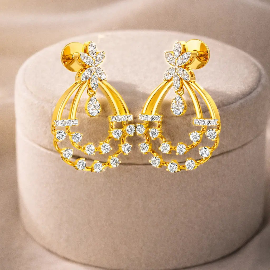 Gold earrings with diamond accents on a beige jewelry box
