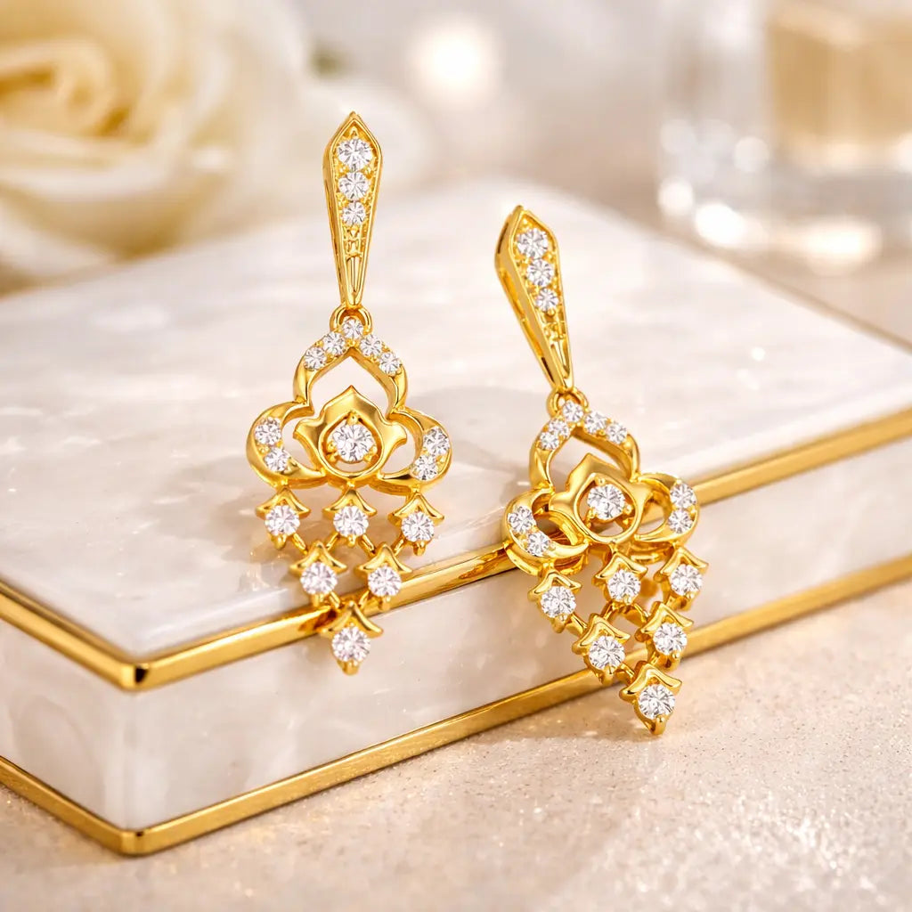 Gold earrings with diamond accents on a decorative stand