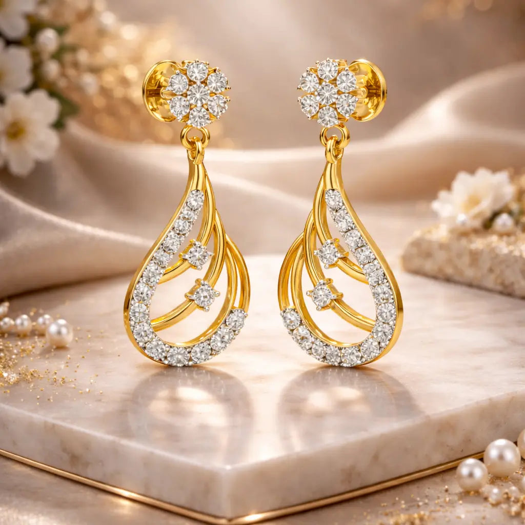 Gold and diamond earrings on a marble surface with flowers in the background
