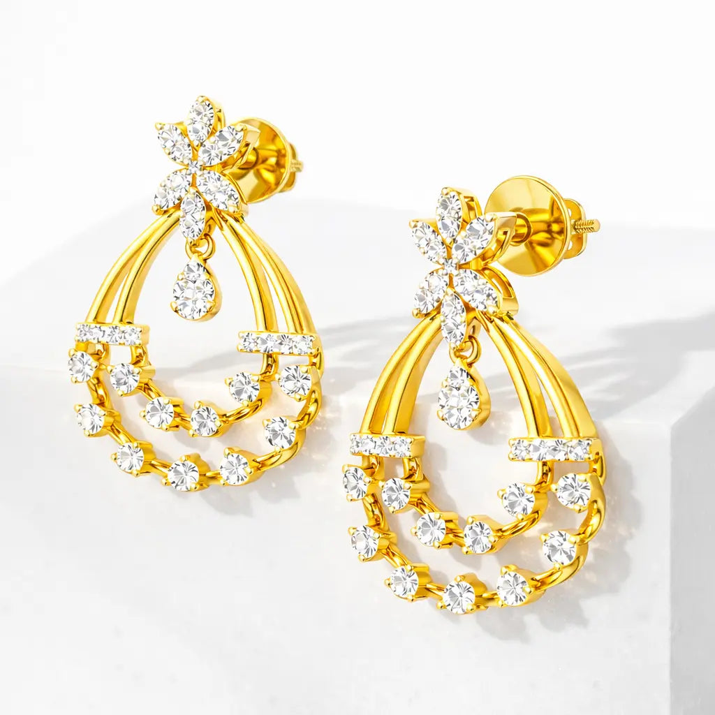 Gold earrings with clear gemstones on a white background