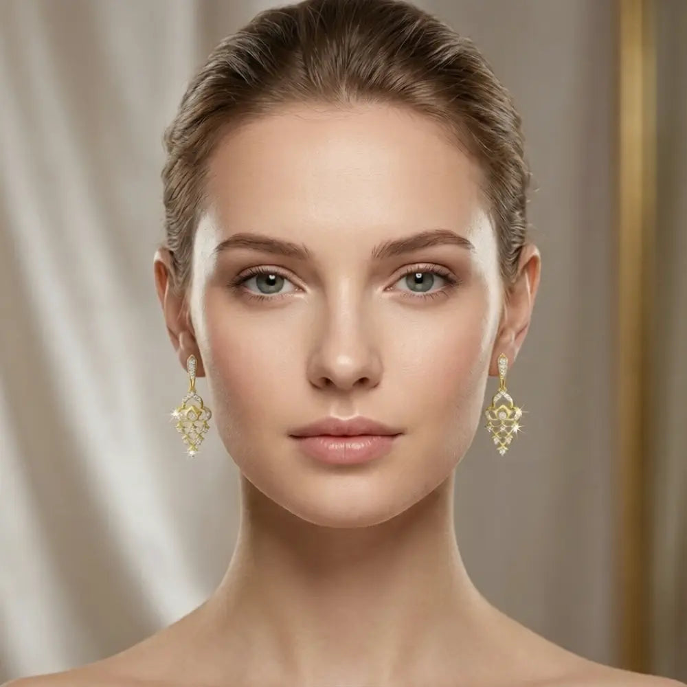 Woman wearing gold earrings with a neutral background