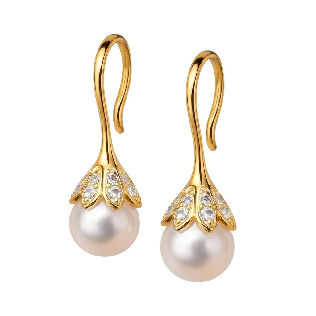 Gold earrings with pearl drops on a white background