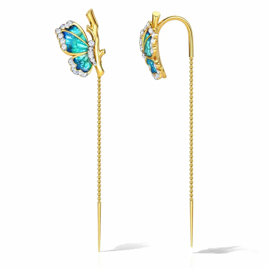 Butterfly-shaped earrings with gold and blue design on a white background