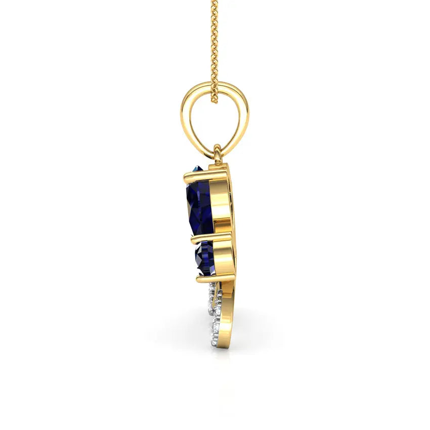 Gold pendant with blue gemstones on a white background