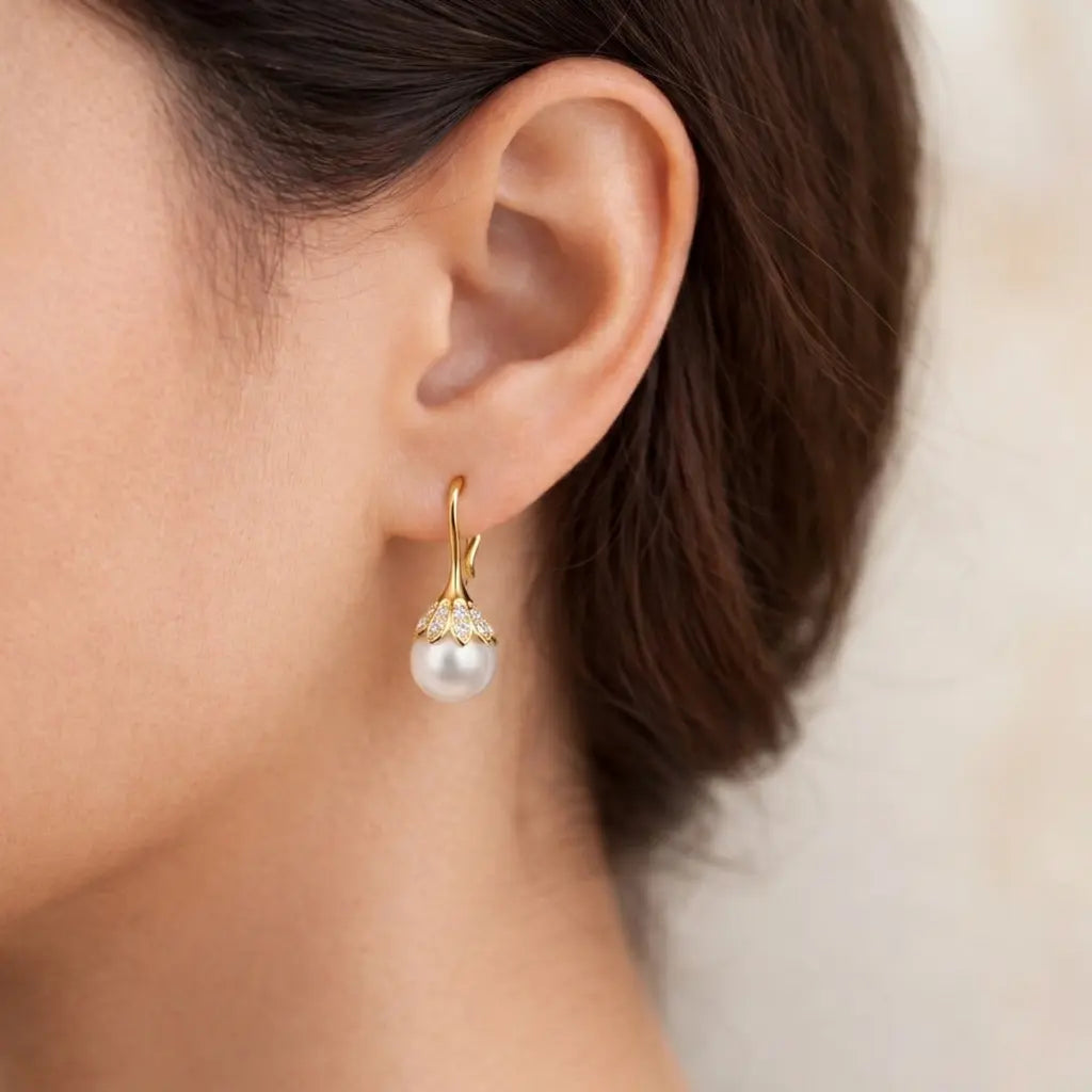 Pearl earring worn by a person with a neutral background