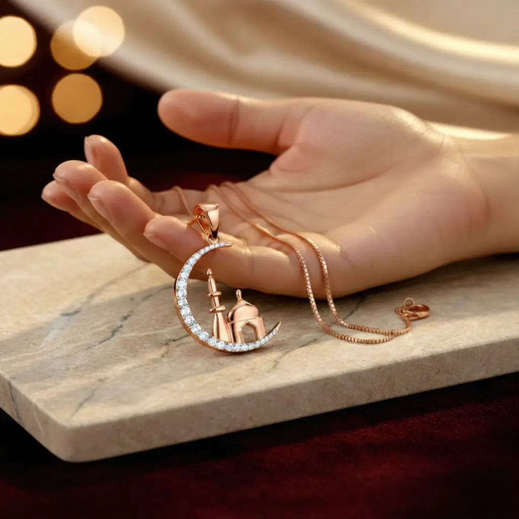 Rose gold necklace with a crescent moon and star pendant held in a hand on a marble surface.