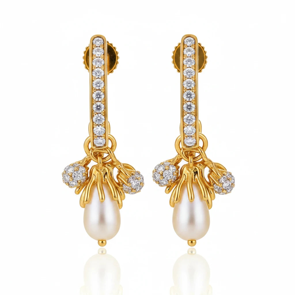 Gold earrings with pearls and gemstones on a soft background