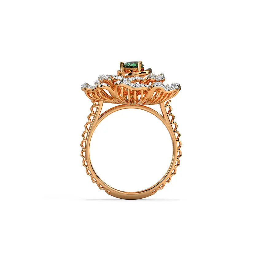 Gold ring with green gemstone and diamond accents on a white background