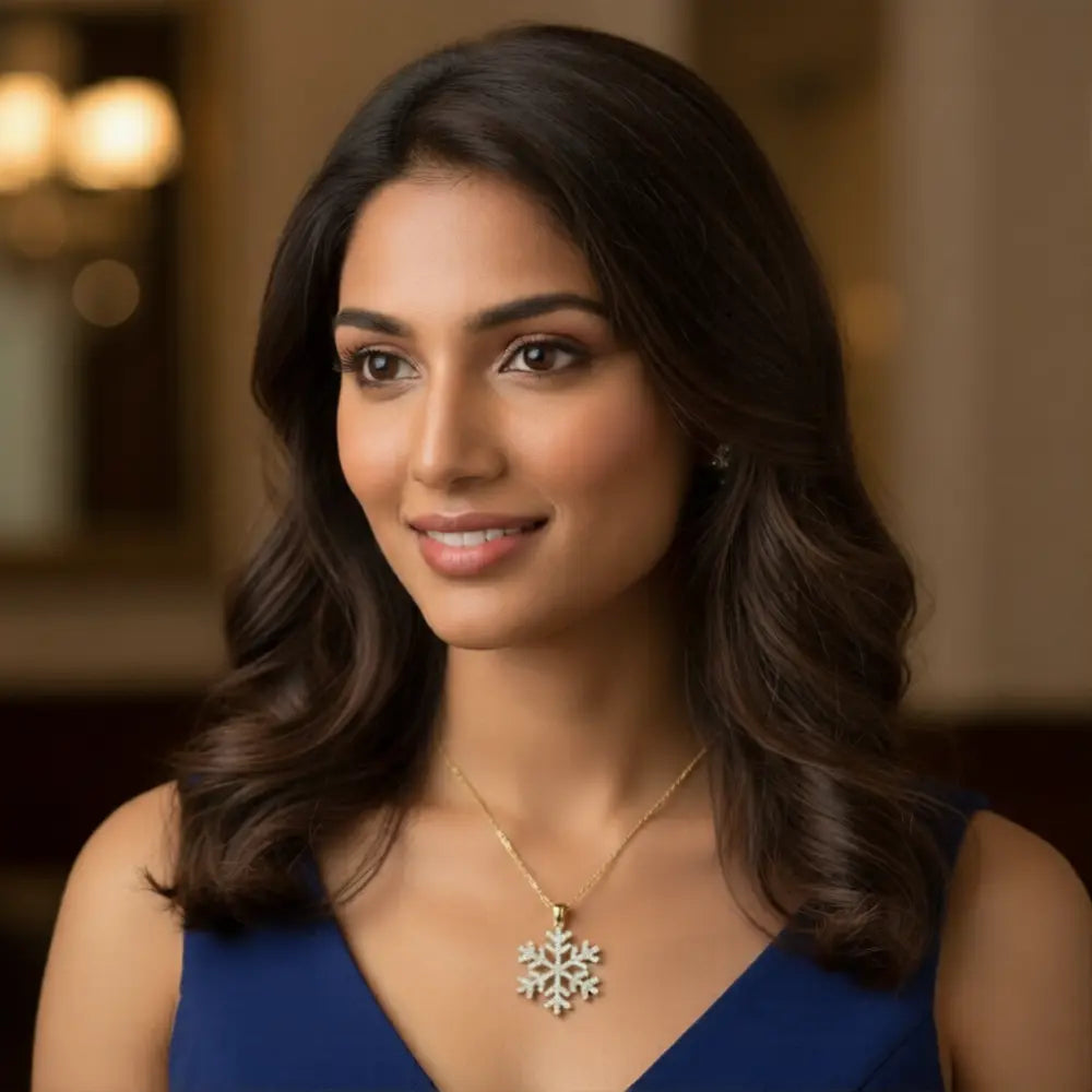 Woman wearing a blue dress with a snowflake necklace in an indoor setting