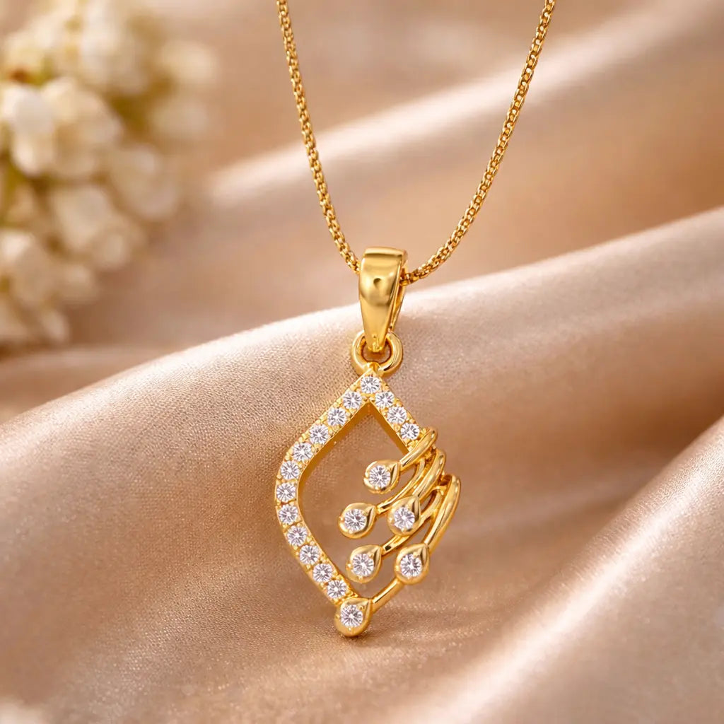 Gold necklace with a diamond-encrusted pendant on a soft fabric background