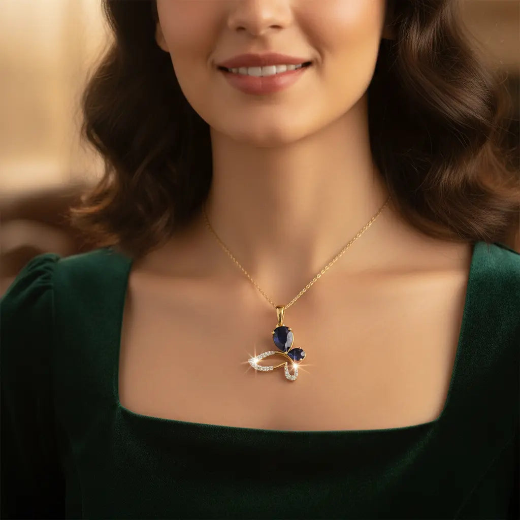 Woman wearing a gold necklace with a blue pendant