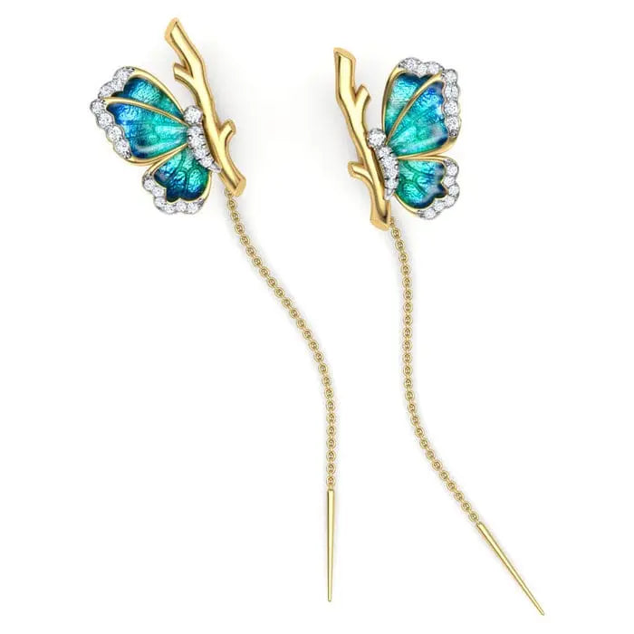 Butterfly-shaped earrings with gold and blue design on a white background