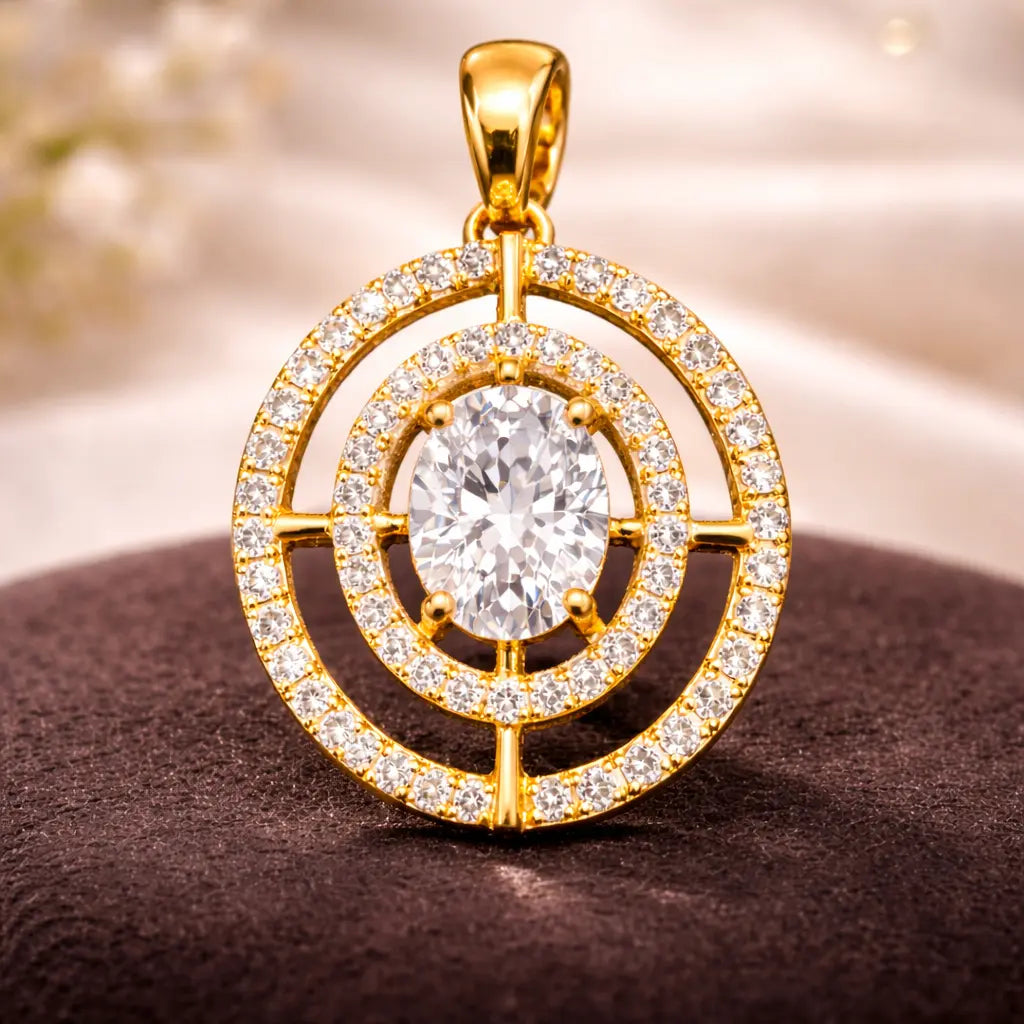 Gold pendant with a large central gemstone and smaller stones around on a brown surface.