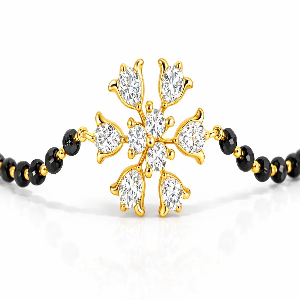 Gold and black beaded bracelet with a decorative clasp on a white background