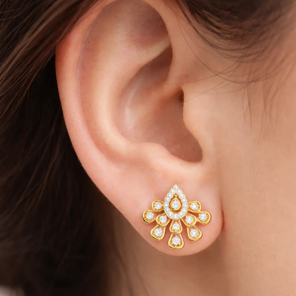 Gold and diamond earring on a person's ear