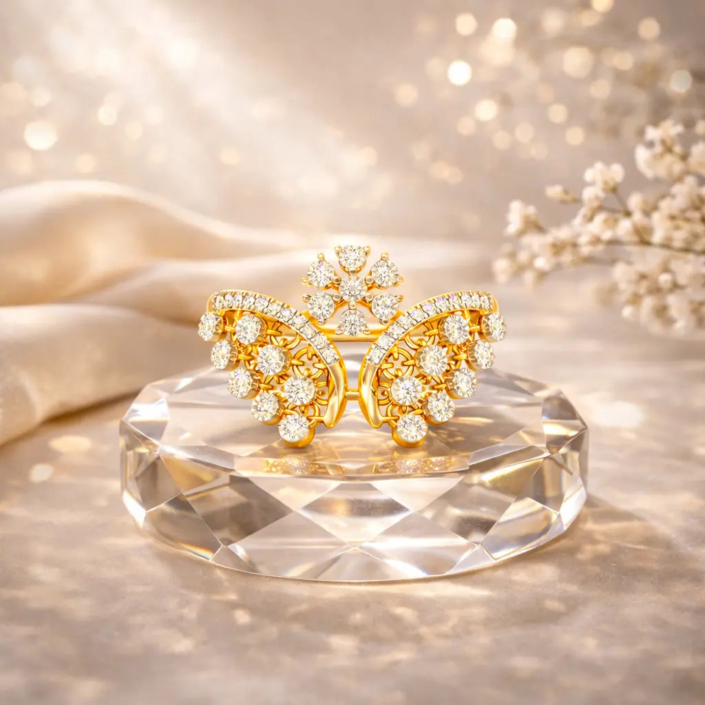 Gold butterfly earrings with diamond accents on a clear crystal stand against a soft, blurred background.