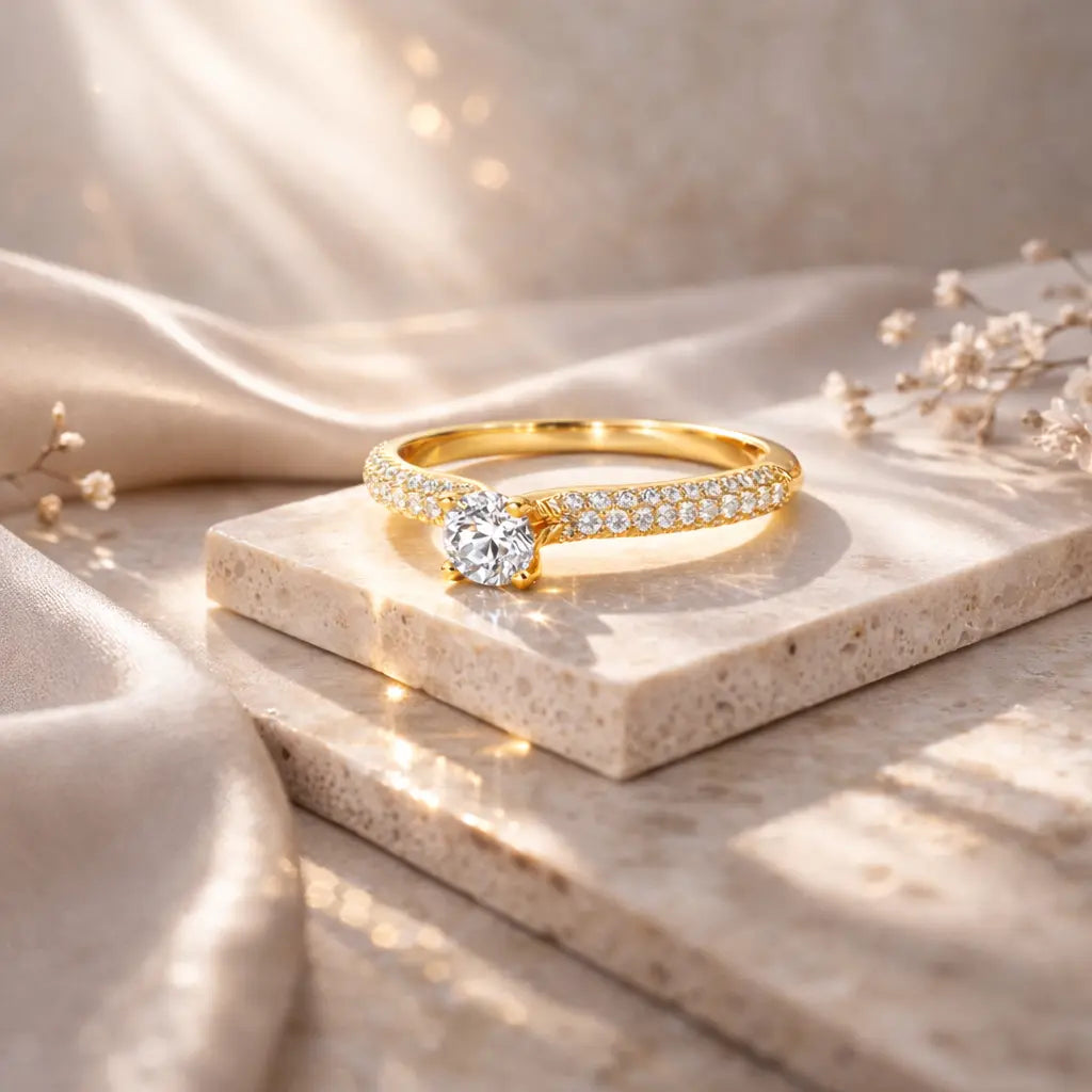 Gold ring with a diamond on a beige stone surface with soft lighting