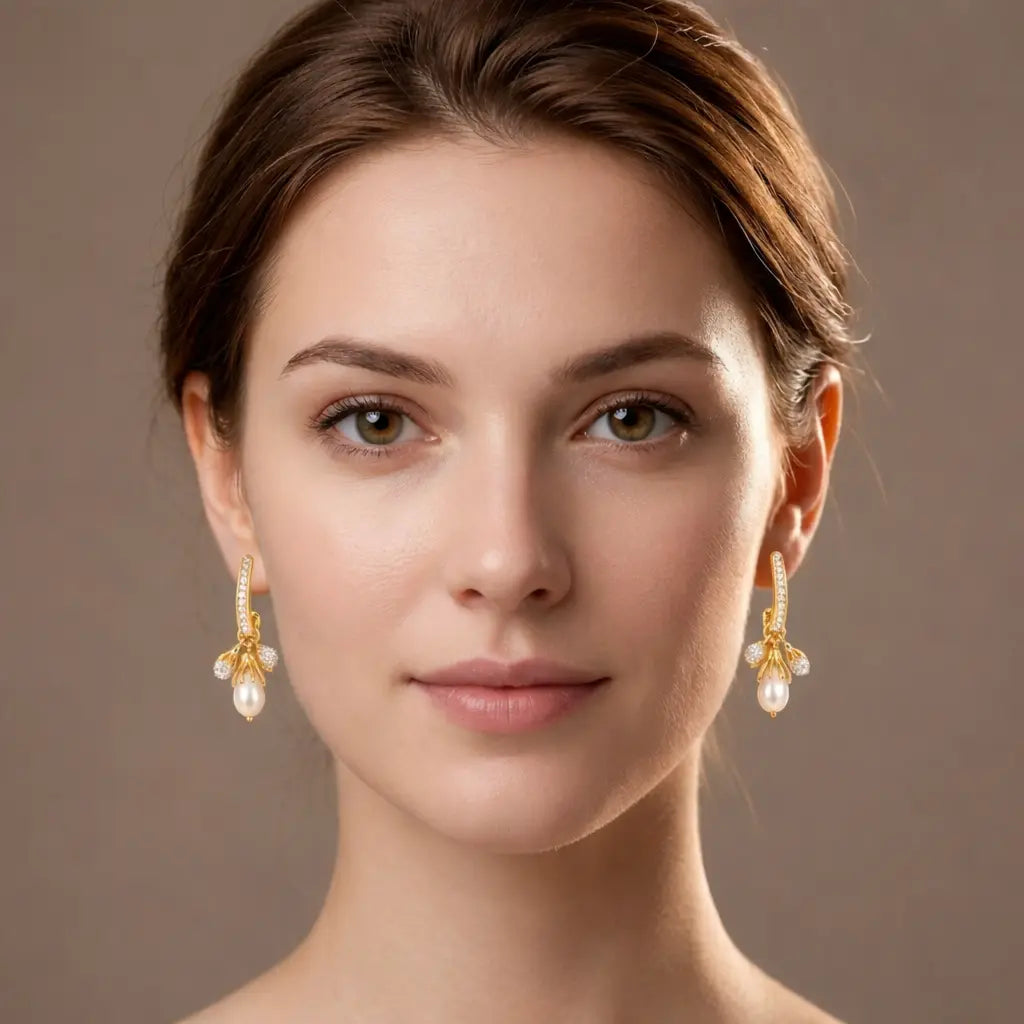 Woman wearing gold earrings with a neutral background