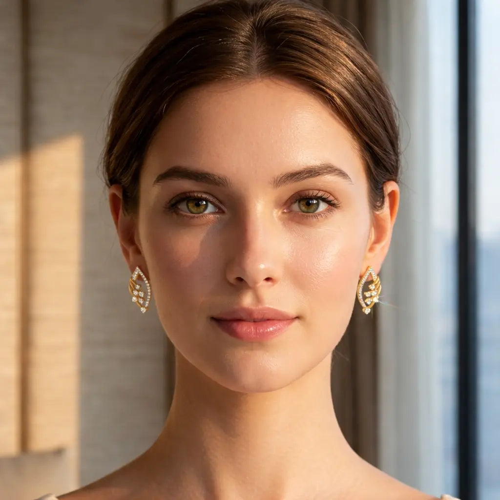 Woman wearing gold earrings with a blurred background
