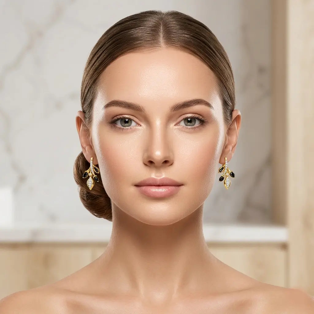 Woman wearing gold earrings with a neutral background