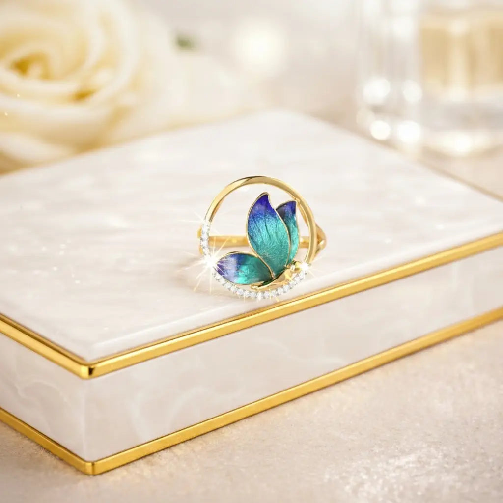 Decorative ring with butterfly design on a white jewelry box