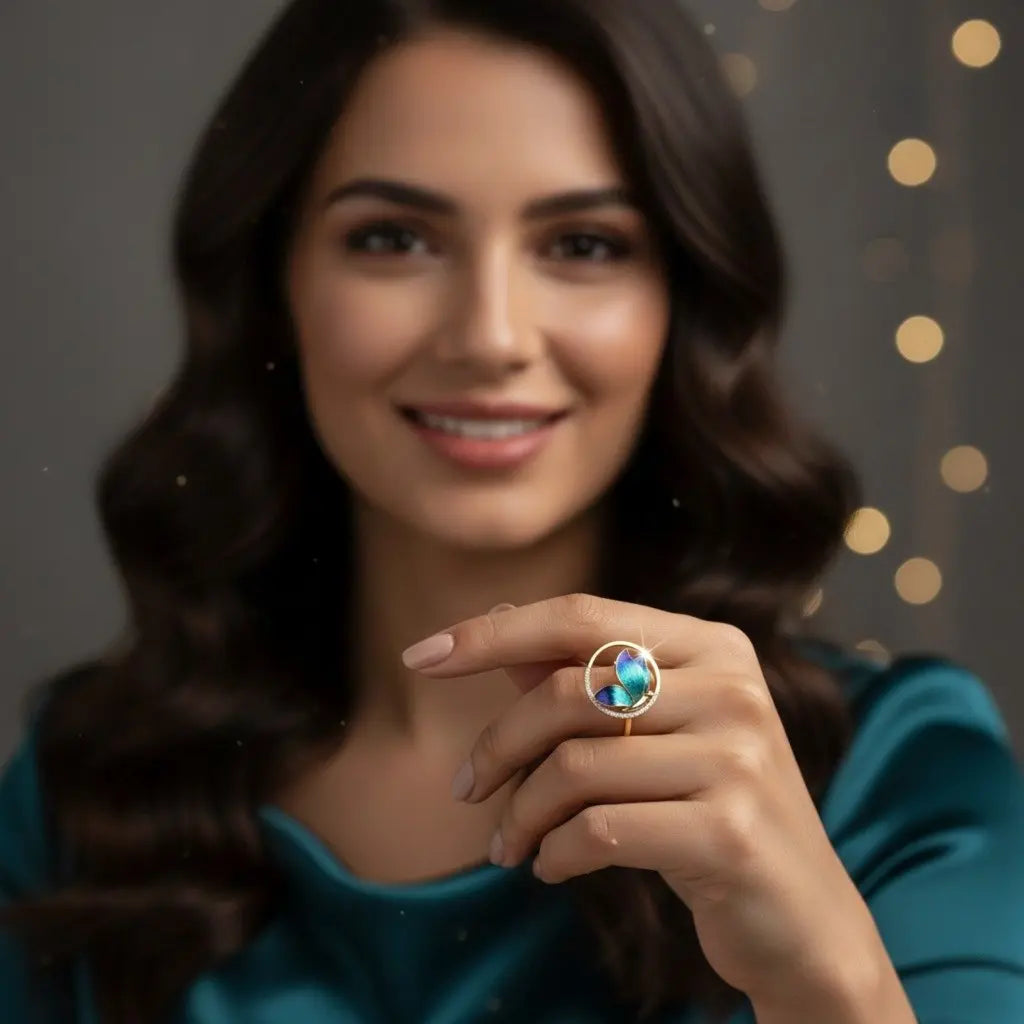 Woman holding a ring with a blue gemstone against a dark background