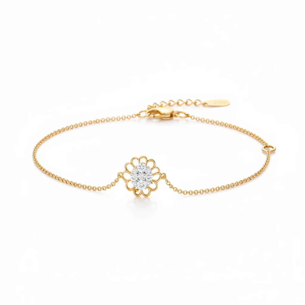 Gold bracelet with a floral clasp on a soft, light background