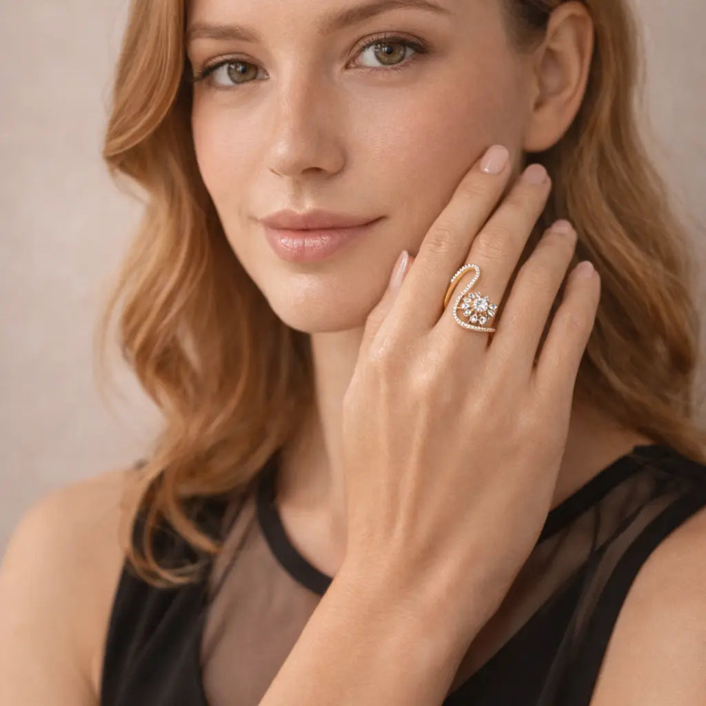 Woman wearing a gold ring with a diamond on a neutral background