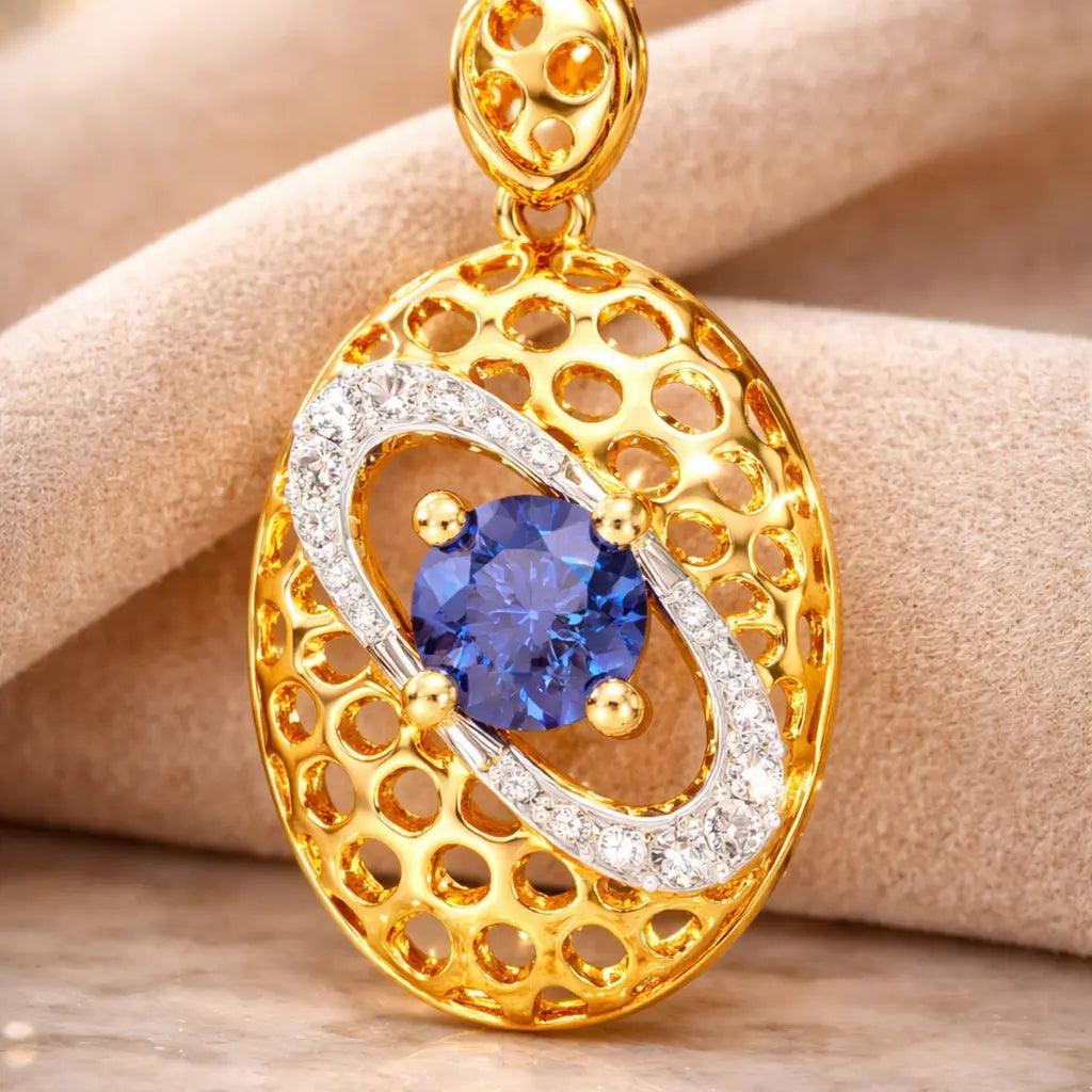 Gold and silver pendant with a blue gemstone on a beige fabric background